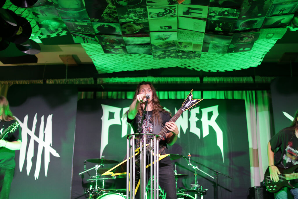 Jon Dickinson of Passing Pluto playing on stage at the Owl Acoustic Lounge in Lethbridge, Alberta on June 6, 2025